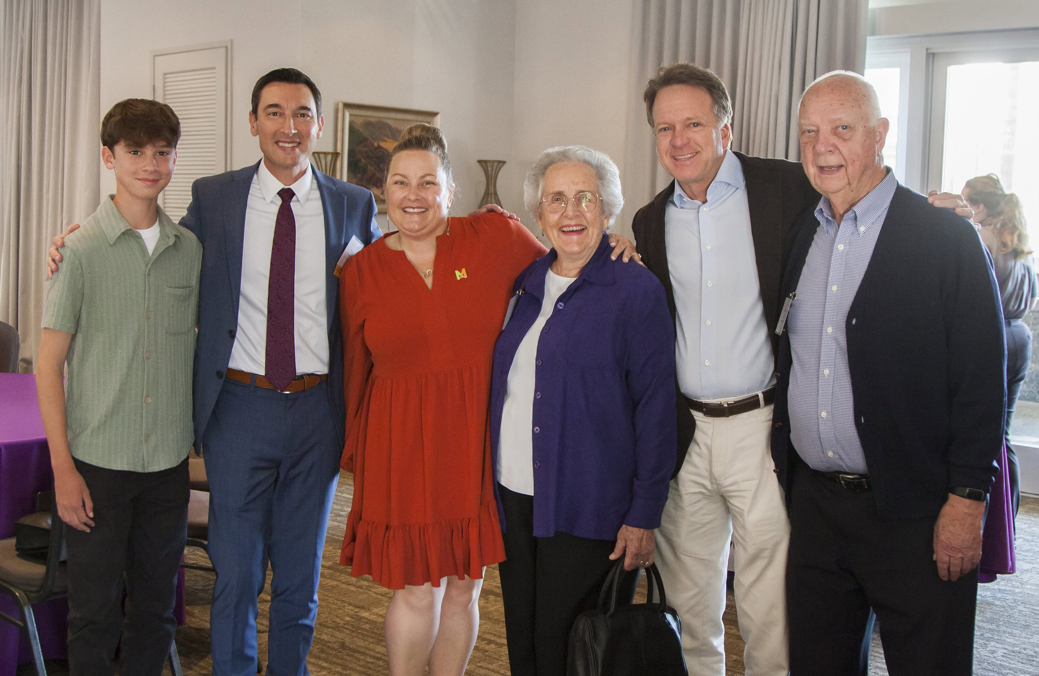 Attendees smiling at an event.