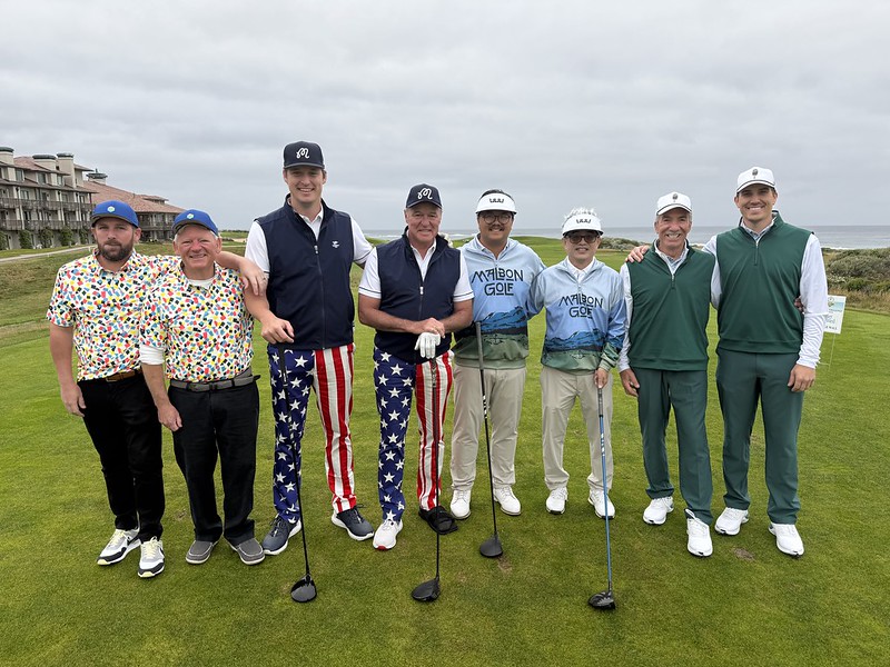 People taking a photo at a golf event.