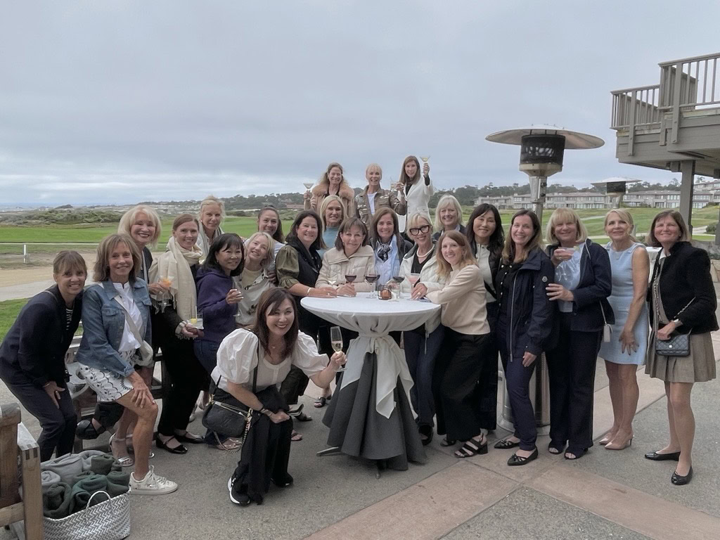 A group of people taking a photo with drinks at an event