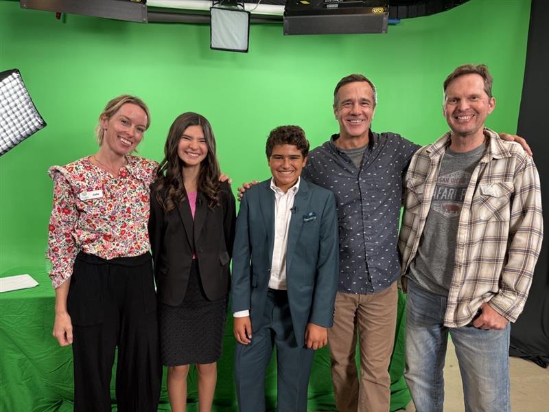 Cube Studio team filming in front of a green screen for science and technology programs, engaging children in STEM activities.