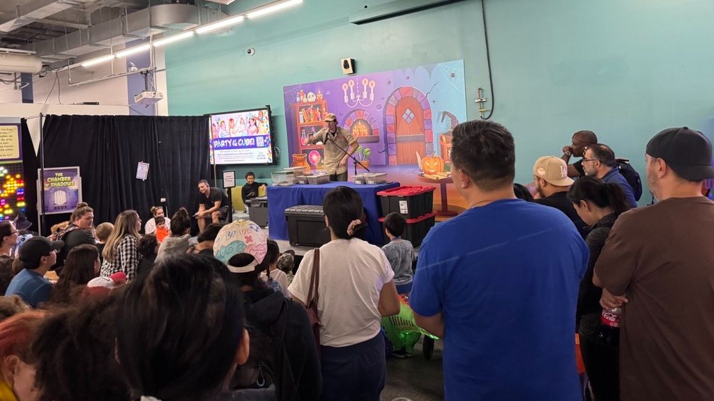 People gathering for a science demonstration at the Enchanted Halloweekends Member Event at Discovery Cube Los Angeles.