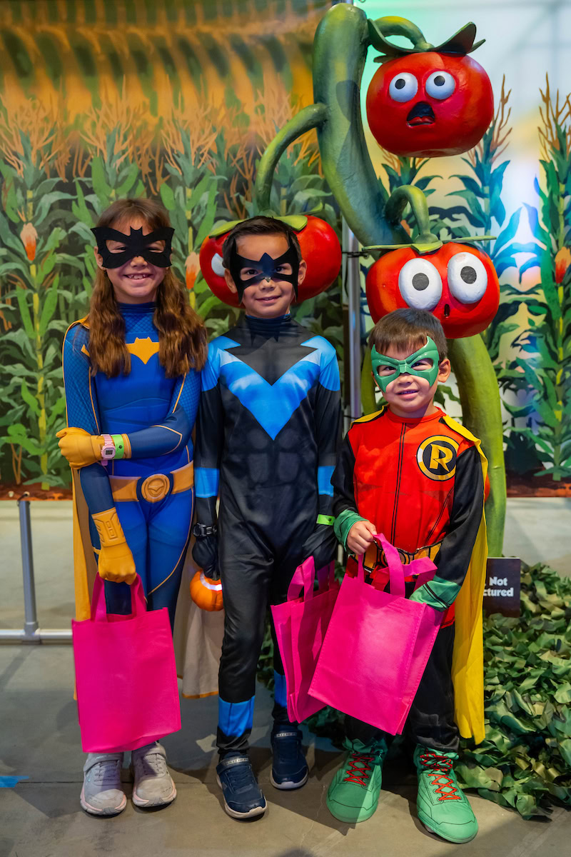 A group photos of kids in front of the Pumpkin Paths Maze at the Pumpkin Palooza Member Preview at Discovery Cube Orange County.